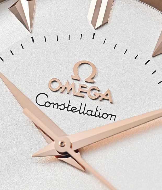 Omega’s Constellation has long been the maison’s signature of sensual elegance. The 38mm rose gold case retains the iconic claws gripping the bezel, while polished edges play with light against a refined brown alligator strap.