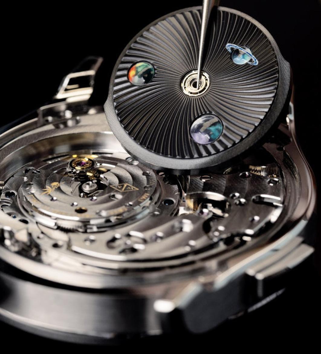 The Midnight Jour Nuit Phase de Lune uses a rotating 24-hour disc to guide the sun and moon across a black aventurine dial, featuring a \"moment on demand\" complication that triggers a full rotation at the wearer\'s desire.